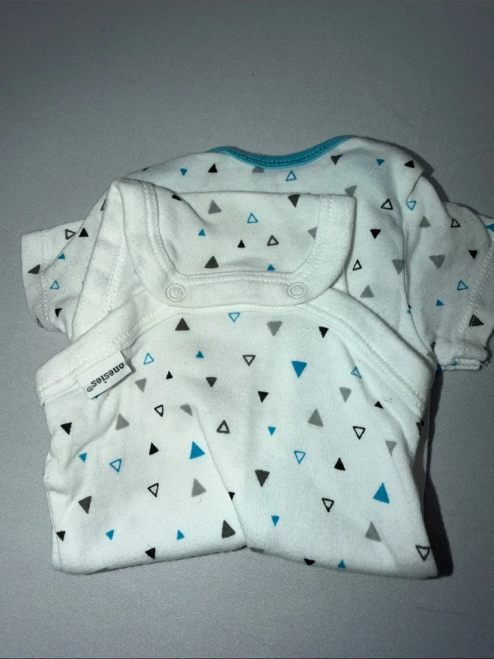 White Baby Onesie with Blue and Gray Triangle Print